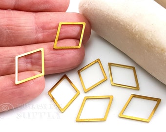 May include: A set of seven gold-colored diamond-shaped metal frames. The frames are about 1 inch in size and have a smooth, polished finish.