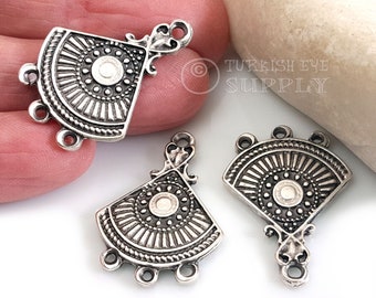 May include: Three silver-toned metal pendant connectors with a fan-shaped design and three loops. The connectors have a decorative, ornate design with a circular pattern in the center.