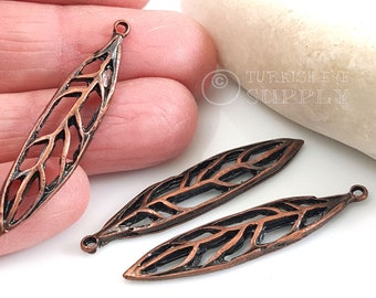 May include: Three copper-colored metal leaf-shaped charms with a delicate, intricate design. Each charm has a loop at the top for attaching to jewelry or other crafts.