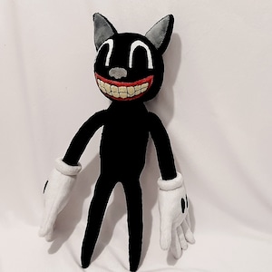 May include: A black cartoon cat plush toy with a wide, toothy grin. The cat has large, white eyes and red lips. The cat is wearing white gloves and has a long, thin body.