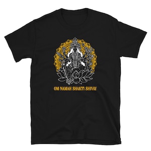 May include: Black t-shirt with a white illustration of a deity with multiple arms, sitting on a lotus flower. The deity is surrounded by a yellow mandala. The text "Om Namah Shakti Shivay" is printed below the illustration.