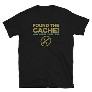 May include: Black t-shirt with the text "FOUND THE CACHE! NOW WHERE IS THE CAR?" in yellow and green. A yellow X is drawn in the centre of the shirt.
