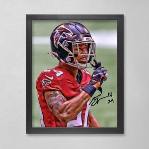 May include: Framed print of an American football player in a red jersey with white accents and the number 4. The player wears a black helmet with a red and white logo. The image includes a signature.