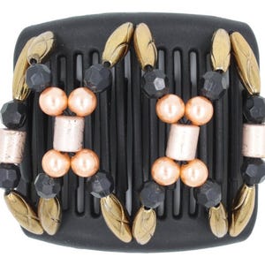 May include: Black hair comb with gold and peach colored beads. The comb has a decorative design with gold accents.
