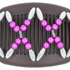 May include: A brown plastic hair comb with silver and pink beads. The comb has a decorative design with silver beads and pink beads.