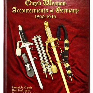 May include: A white ceramic mug with a black handle and the text "But First, Coffee" in a black, bold font. The mug is on a white surface.