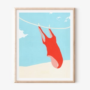 May include: A red swimsuit hanging on a clothesline against a blue sky and white sand background.