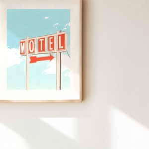 May include: A framed illustration of a vintage motel sign with the word "MOTEL" in red letters and a red arrow pointing to the right. The sign is against a blue sky with white clouds.