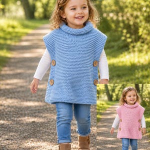 May include: A baby blue knitted poncho with a roll neck and wooden buttons. The poncho is worn over a white long-sleeved top, paired with blue jeans and brown boots. A second image shows a pink poncho.