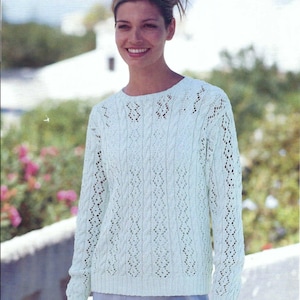 May include: A light green, long-sleeved sweater with a detailed open-knit design. The sweater has a round neckline and is shown with measurements of 32-42 inches (81-107 cm). The word "CRYSTAL" is visible in the bottom right corner.
