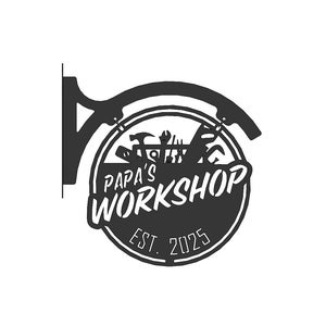 May include: Black metal sign with the text "Papa's Workshop" in a stylized font, featuring tools inside a circular frame. The sign includes "Est. 2025" and is designed to hang from a bracket.