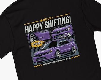 May include: A black t-shirt with a purple Subaru Impreza WRX STI printed on the back. The car is surrounded by Japanese text and the words "Happy Shifting!" and "The Wandering Daisy & Co."