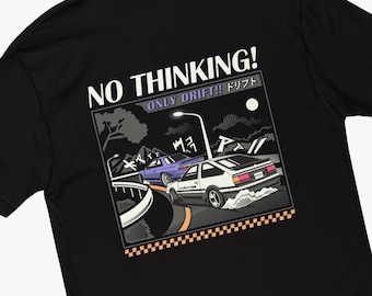 May include: Black t-shirt with a graphic of two cars drifting on a road at night. The text "NO THINKING! ONLY DRIFT!! ドリフト" is printed on the shirt.