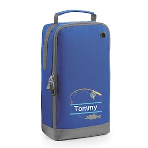 May include: Blue shoe bag with a fishing rod and fish design. The bag has a zipper and a handle. The name "Tommy" is embroidered on the bag.