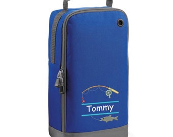 May include: Blue shoe bag with a fishing rod and fish design. The bag has a zipper and a handle. The name "Tommy" is embroidered on the bag.