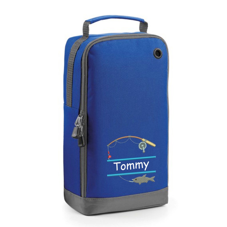 May include: Blue shoe bag with a fishing rod and fish design. The bag has a zipper and a handle. The name "Tommy" is embroidered on the bag.