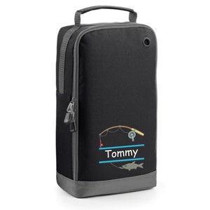 May include: Black shoe bag with a gray zipper and a gray bottom. The bag has a fishing rod and fish design with the name "Tommy" printed on it.