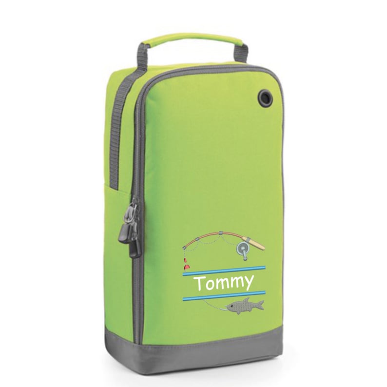 May include: A lime green shoe bag with a gray zipper and handle. The bag has a fishing rod and fish design with the name "Tommy" embroidered on it.