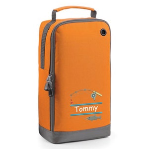 May include: Orange and gray shoe bag with a zipper closure and a handle. The bag has an embroidered design of a fishing rod, reel, and fish with the name "Tommy" written below.