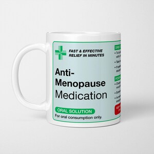 May include: A white ceramic mug with a green and black label that reads "Anti-Menopause Medication." The label also includes the text "Fast & Effective Relief in Minutes" and "Oral Solution."
