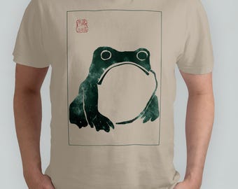 感動しないカエル。ユニセックスTシャツ、松本宝治によるヴィンテージ