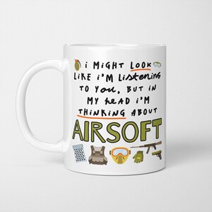 May include: White ceramic mug with the text "I might look like I'm listening to you, but in my head I'm thinking about Airsoft." The mug features illustrations of Airsoft gear, including a grenade, goggles, and a vest.