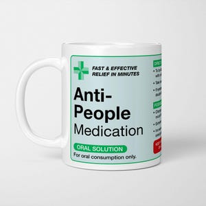 May include: White ceramic mug with a green and white label. The label reads "Anti-People Medication" with the words "Fast & Effective Relief in Minutes" and "Oral Solution". The mug has a white handle.