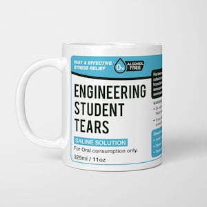 May include: White ceramic mug with a blue and white label that reads "Engineering Student Tears Saline Solution For Oral consumption only. 325ml/11oz". The label also has a blue and white 0% Alcohol Free logo.