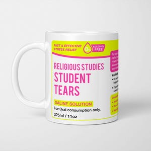 May include: White ceramic mug with a yellow and pink label that reads "Fast & Effective Stress Relief", "0% Alcohol Free", "Religious Studies Student Tears", "Saline Solution", "For Oral consumption only", "325ml/11oz".