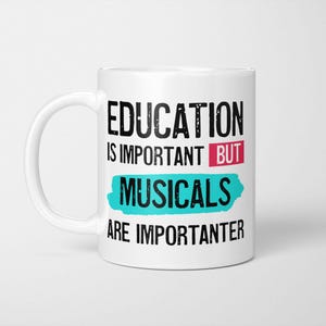 May include: A white ceramic mug featuring black text that reads EDUCATION IS IMPORTANT BUT MUSICALS ARE IMPORTANTER. The word BUT is highlighted by a pink rectangle, and the word MUSICALS is set against a bright turquoise brushstroke background.