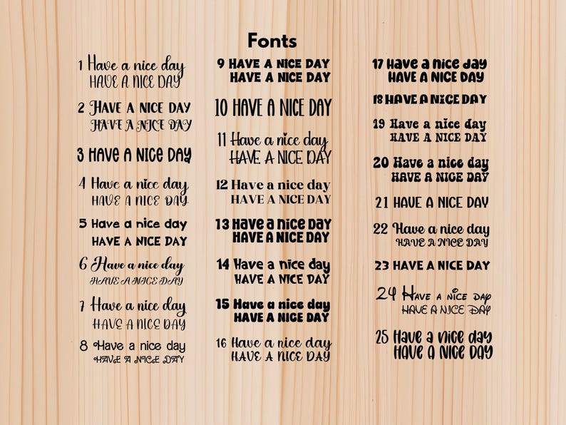 May include: A wooden background displays 25 different font styles of the phrase "Have a nice day." Each style is presented twice, once in a larger, more decorative font and again in a smaller, simpler font.