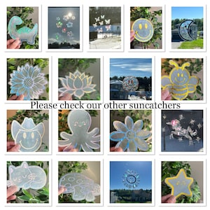 May include: A collection of iridescent holographic suncatchers featuring various designs, including a sunflower, a lotus flower, a bee, an octopus, a mushroom, a star, a cat, a dinosaur, a unicorn, and a smiley face.
