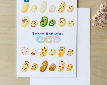 May include: A colourful illustration of various Tokyo Banana flavours. The illustration features different designs on the banana-shaped cakes, including a bear, a cat, a heart, and a polka dot pattern. The text "Tokyo Bananas" and "東京ばな奈" is written in both English and Japanese.
