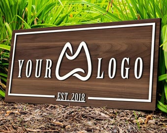 May include: A brown wooden sign with a white border and white text. The text reads "YOUR LOGO EST. 2018". There is a white abstract logo in the center of the sign.
