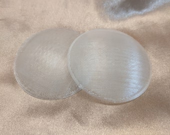 May include: Two white, round, plastic, 3D printed discs.