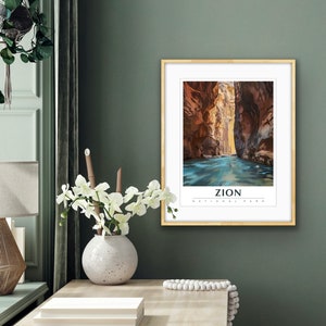 May include: A framed print of a canyon with a river running through it. The print is titled "Zion National Park".