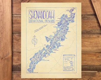 May include: A vintage style map of Shenandoah National Park in Virginia. The map is printed on a beige background with blue lines and text. The map shows the park's trails, roads, and landmarks. The text "Shenandoah National Park" is printed in blue at the top of the map.
