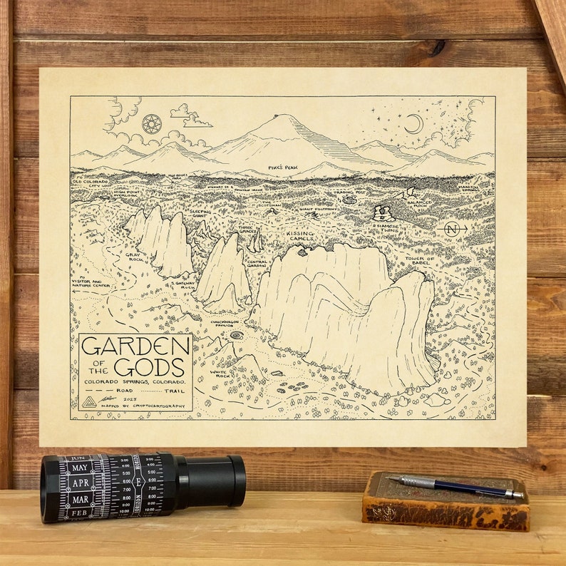 May include: A black and white line drawing map of Garden of the Gods in Colorado Springs, Colorado. The map shows the location of the Kissing Camels, the Balanced Rock, and other notable landmarks. The map is titled "Garden of the Gods" and includes a compass and a scale.