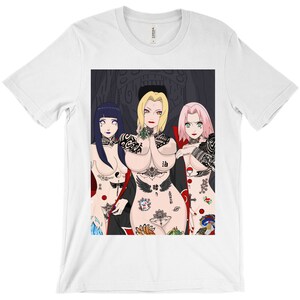 May include: A white t-shirt with a graphic print of three anime characters with tattoos. The characters are a woman with pink hair, a woman with blonde hair, and a woman with black hair. The background is black with a large, menacing face.