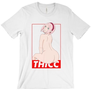 May include: White t-shirt with a red box featuring an anime character with pink hair and the word "THICC" in red letters.