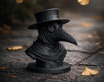 May include: A black plague doctor bust, featuring a distinctive long beak mask and top hat. The sculpture is placed on a stone surface, with autumnal yellow leaves scattered around, evoking a historical theme.