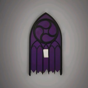 May include: A decorative light switch cover in the shape of a gothic window. The cover is purple with black trim and a white switch. The design includes a circular pattern at the top and arched details.
