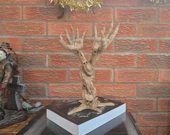 A large gothic Demon hands book stand with skulls unique gift