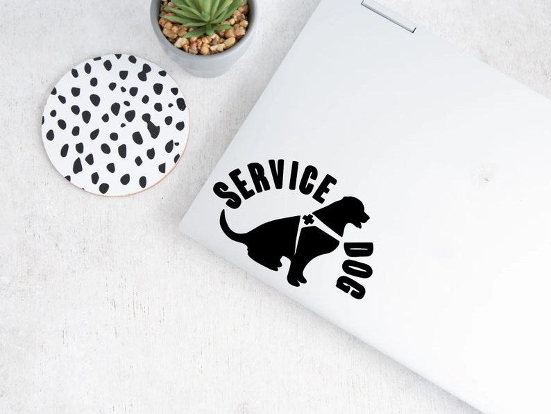 May include: Black and white sticker of a service dog with a harness and the text "SERVICE DOG" in a semi-circle around the dog.