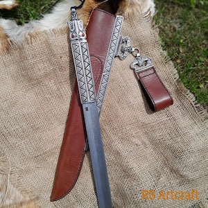 Viking scramasax. Hand-forged Damascus steel blade. Bronze handle with Odin and Dragon heads. Leather sheath. Medieval collectible knife