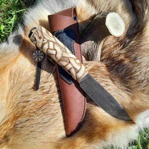 Premium Damascus steel Viking knife with leather sheath and hand-carved Dragon knotwork handle. Hand-forged blade. Norse motifs, Nordic.