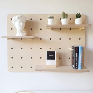 Modern organizer peg board with wooden shelves, children room wall control, minimalist house hallway plywood pegboard, shop product display