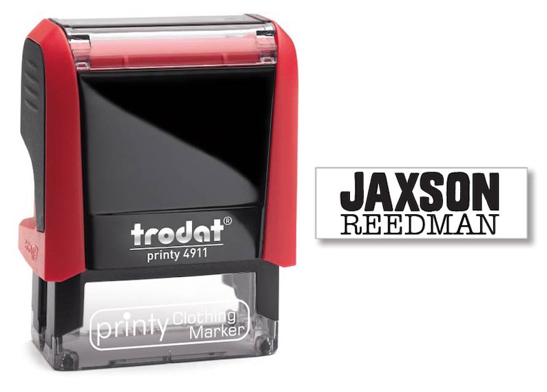 May include: Red and black self-inking stamp with the text "trodat printy 4911" and "printy Clothing Marker". The stamp is designed to print the name "JACKSON REEDMAN" in black ink.
