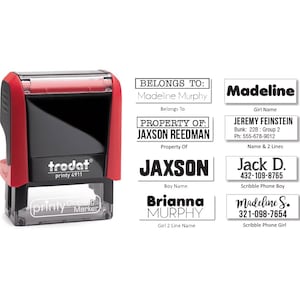 May include: A set of eight black and white self-inking stamps with various text, including "Belongs To: Madeline Murphy", "Property Of: Jaxson Reedman", "Jaxson", "Brianna Murphy", "Madeline", "Jeremy Feinstein", "Jack D.", and "Madeline S.".