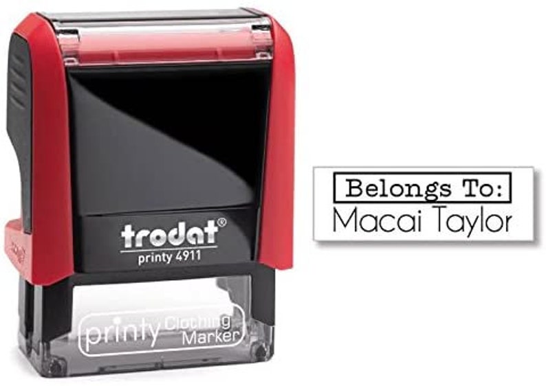 May include: Red and black self-inking stamp with a clear top. The stamp reads "trodat printy 4911" and "printy Clothing Marker". The stamp is designed to print "Belongs To: Macai Taylor".